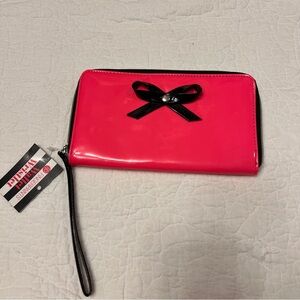 pink patent zip around wallet wristlet with a black bow detail by FINGERPAINTS